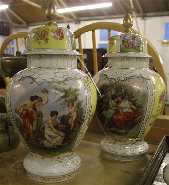 Pair of Continental vases and covers, decorated figures and flowers in reserves (chip to one rim)